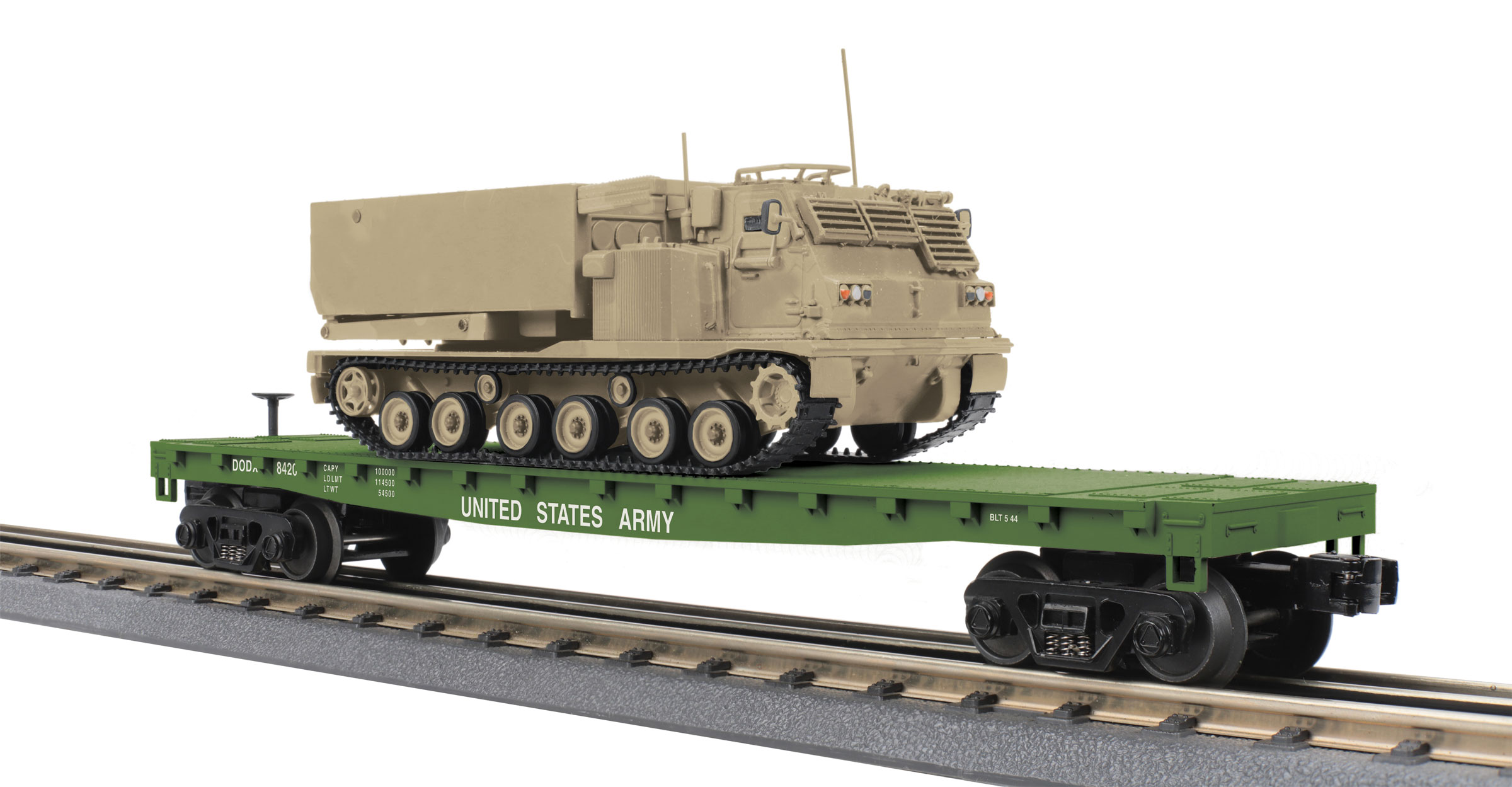 U.S. Army flatcar with tan M270 Rocket Launcher vehicle