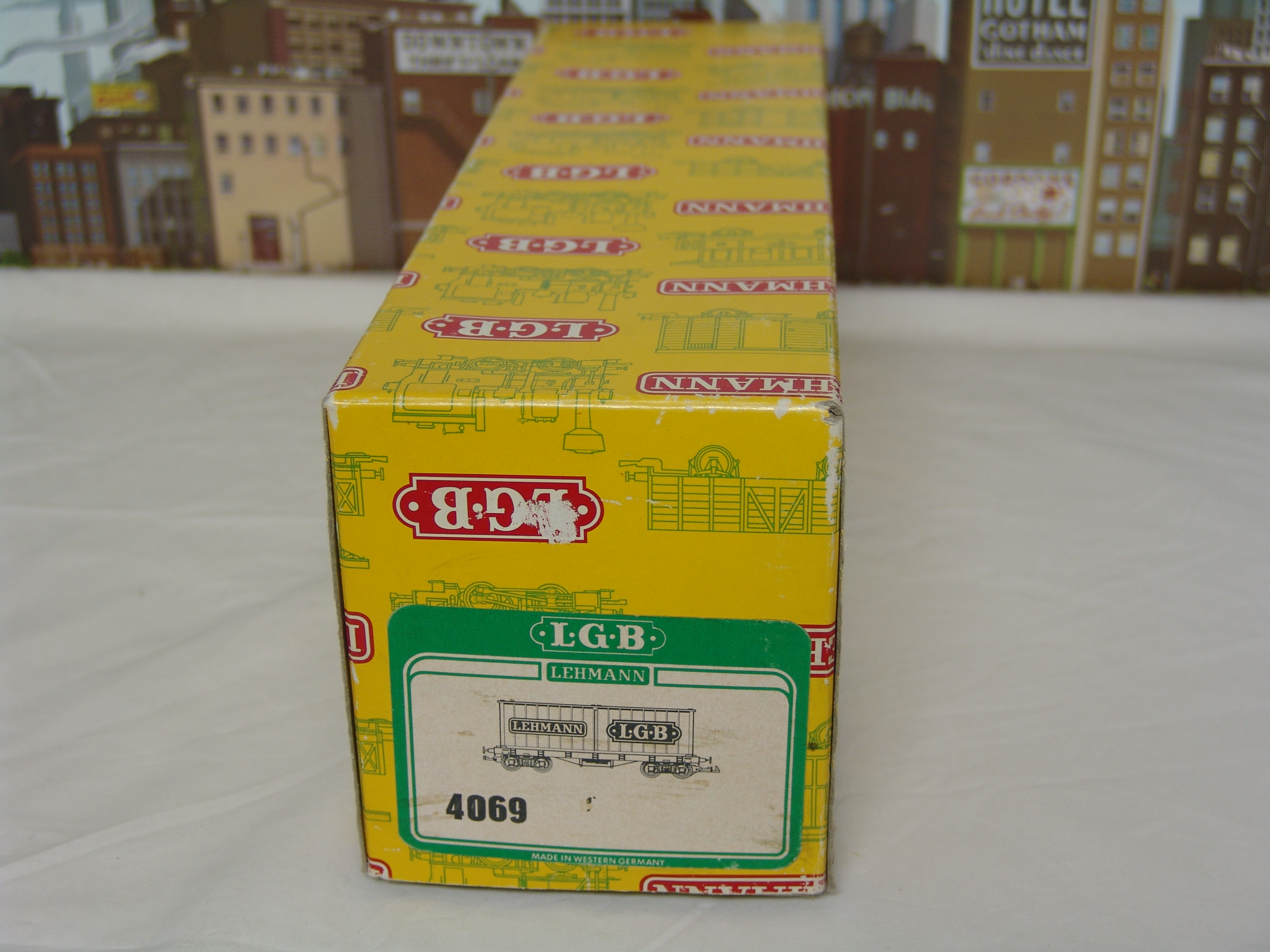black flatcar #4069 with two containers (yellow box, used)