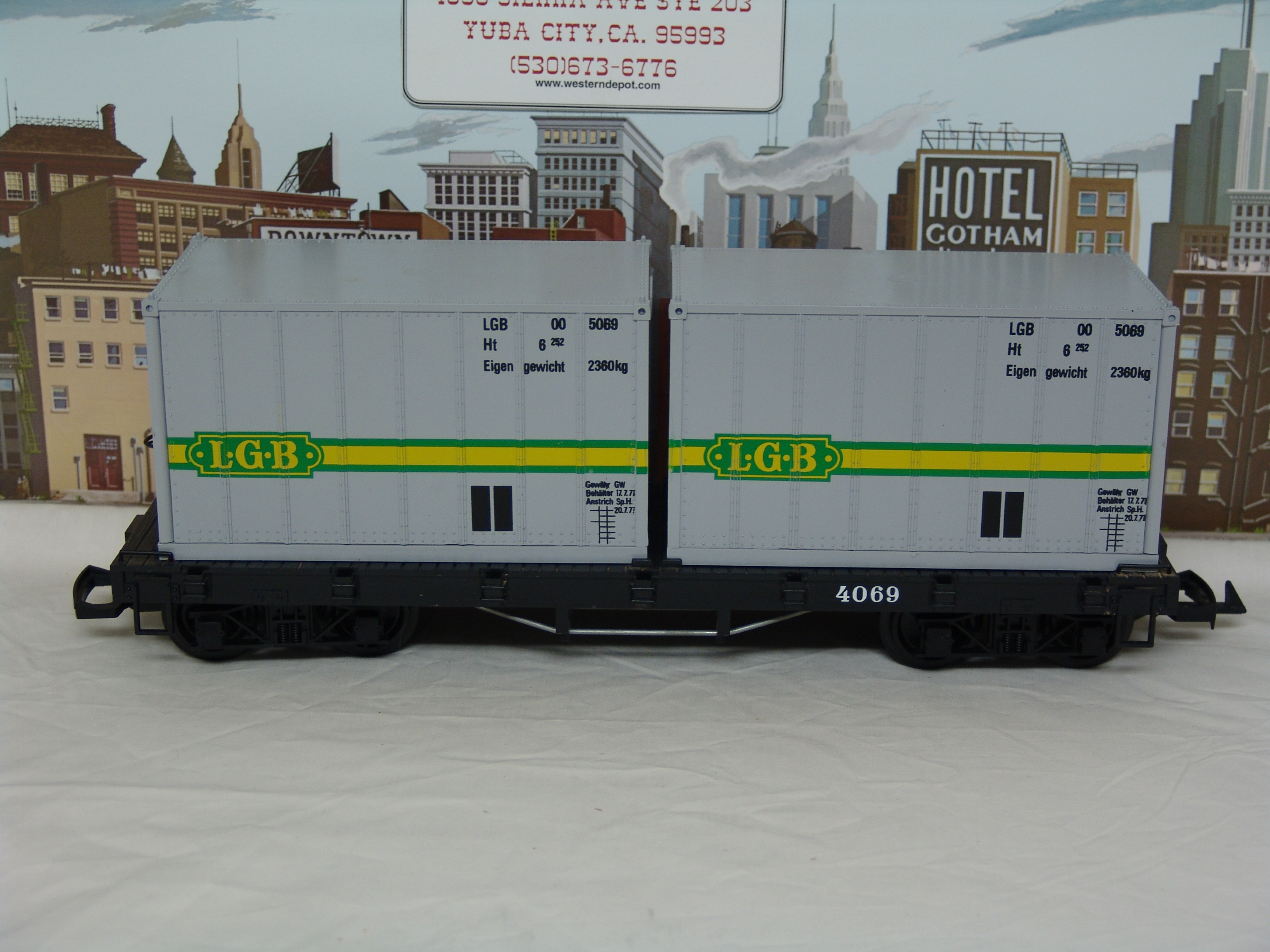 black flatcar #4069 with two containers (yellow box, used)