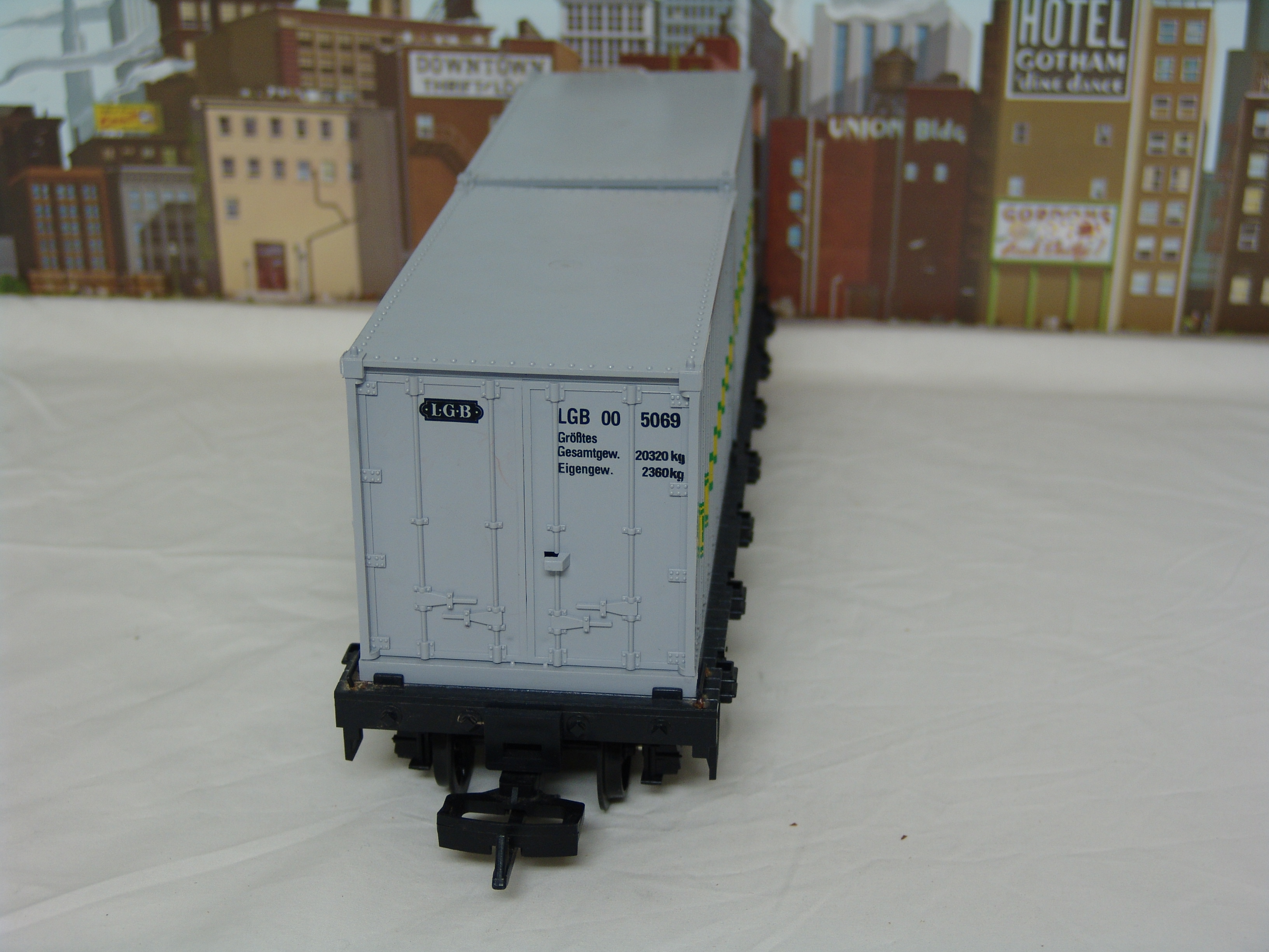 black flatcar #4069 with two containers (yellow box, used)