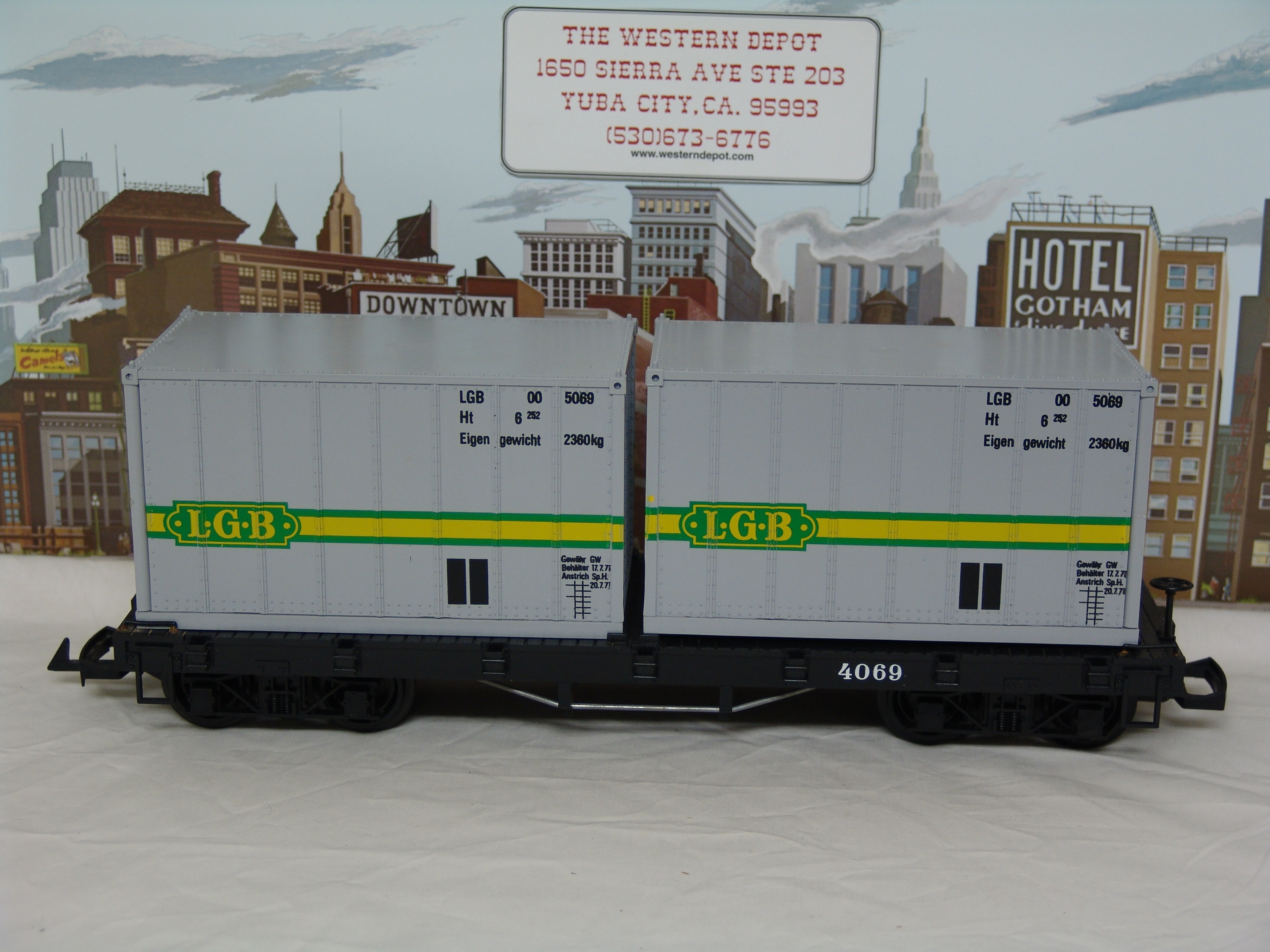 black flatcar #4069 with two containers (yellow box, used)