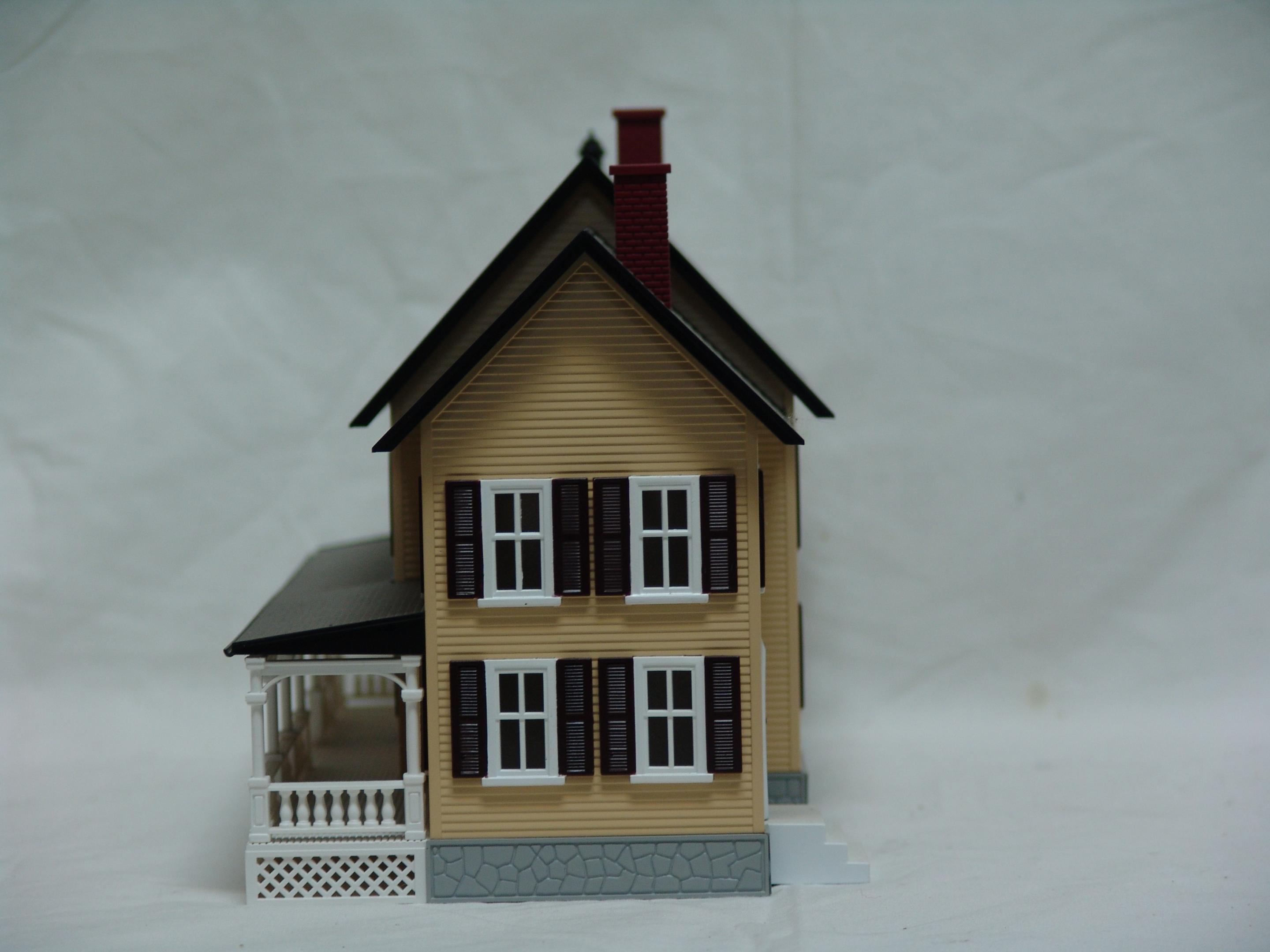 tan with dark brown shutters country house (used)